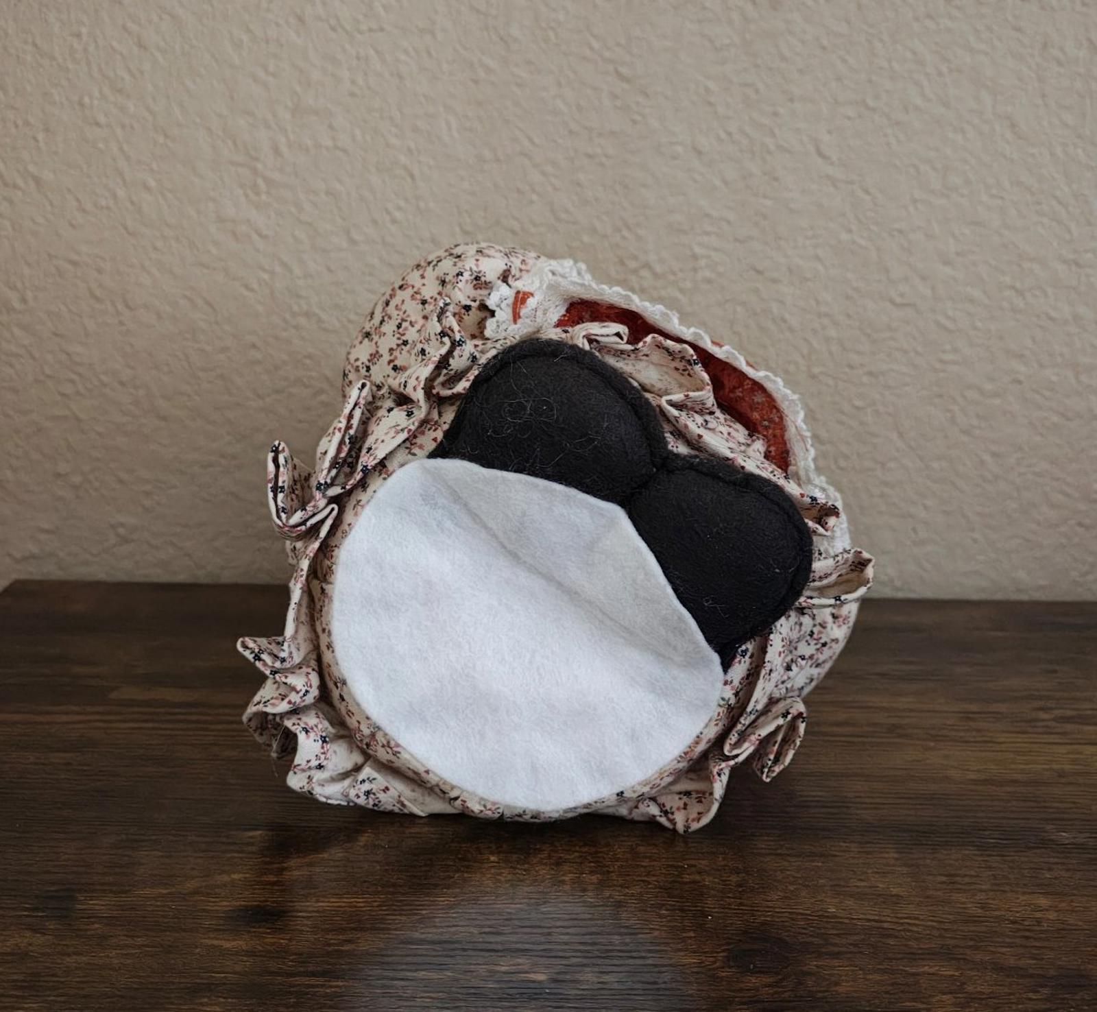 Handmade cloth doll canister with metal pot and fabric cover, side-by-side.