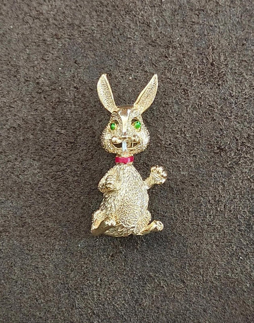 Gold-tone bunny rabbit brooch pin with green eyes and red collar, standing pose.