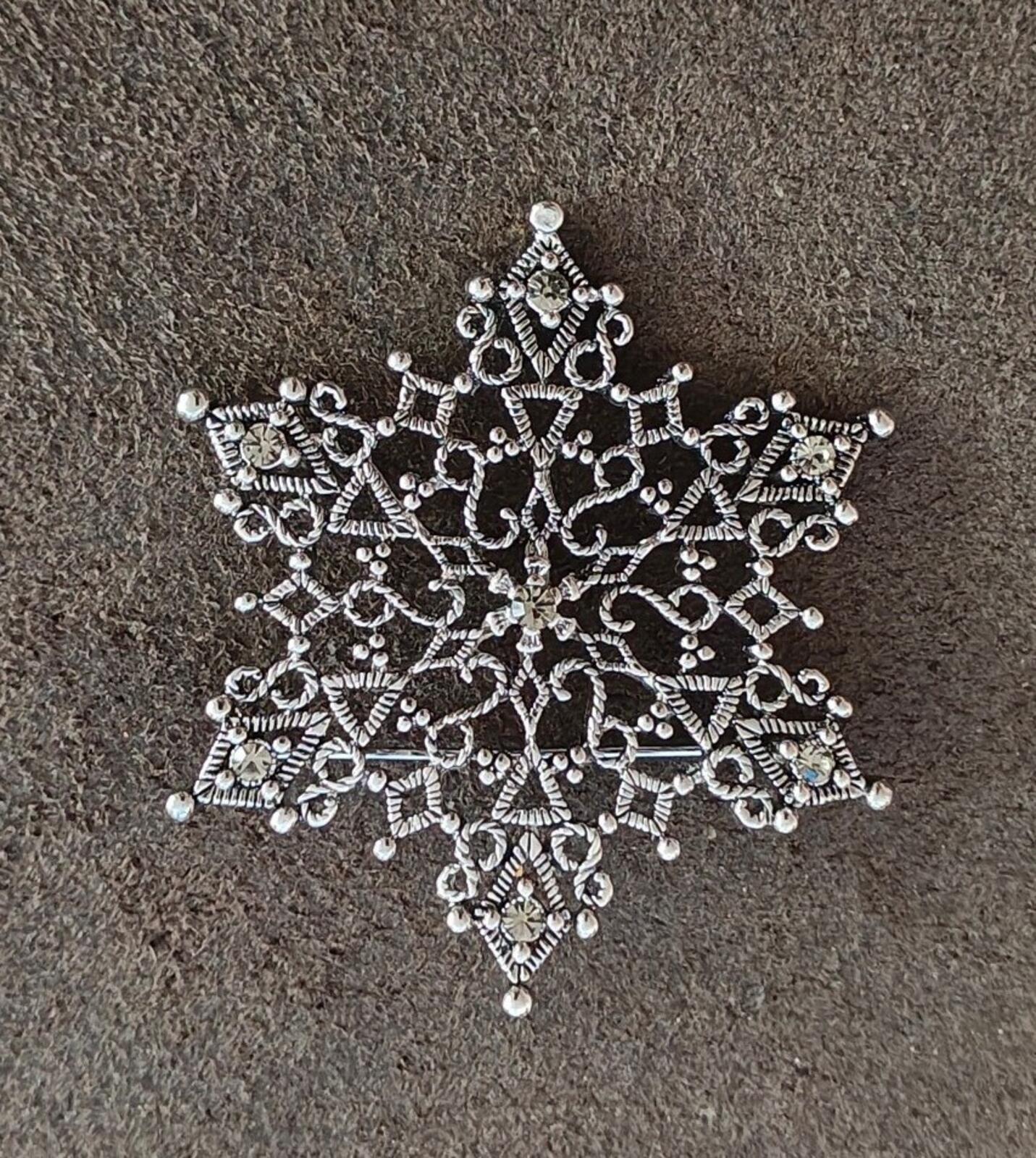 1990s Silver Tone Filigree Snowflake With Clear Rhinestone Accents Brooch.
