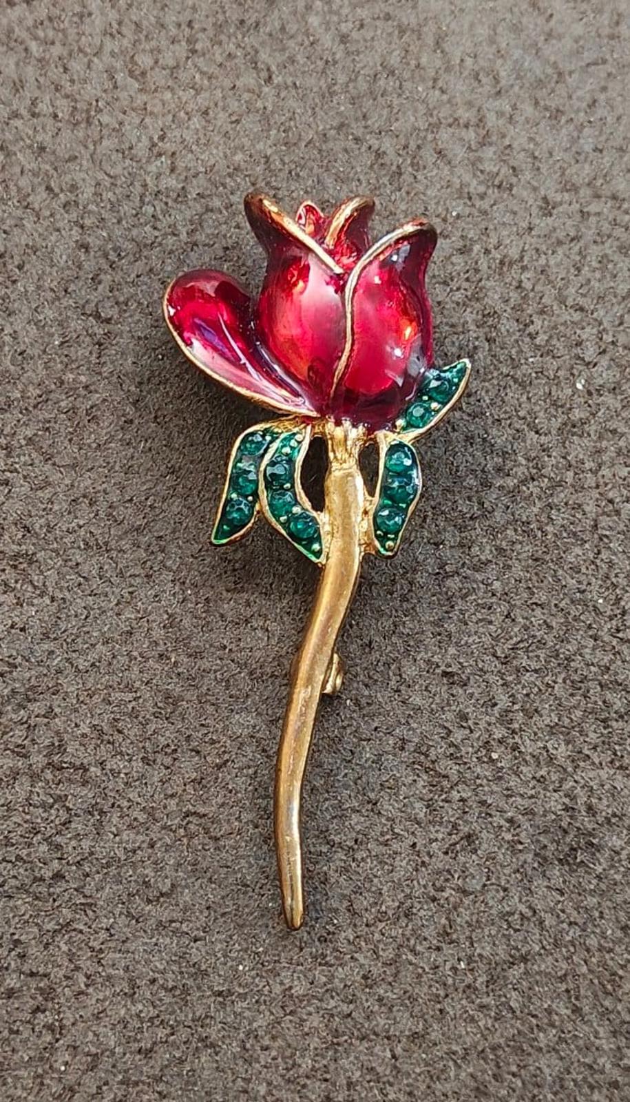 Red enamel tulip-style brooch with green rhinestone accents and gold-tone stem, pin