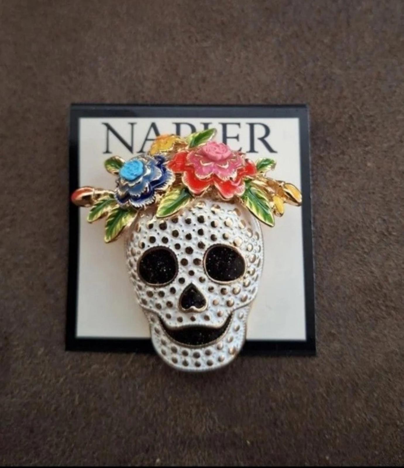 Silver tone sugar skull pin with blue and pink floral accents and black face details