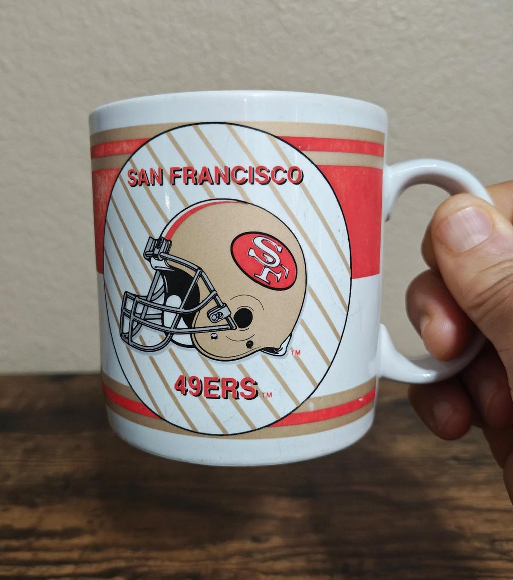 San Francisco 49ers helmet logo mug with red-and-white stripes and handle.