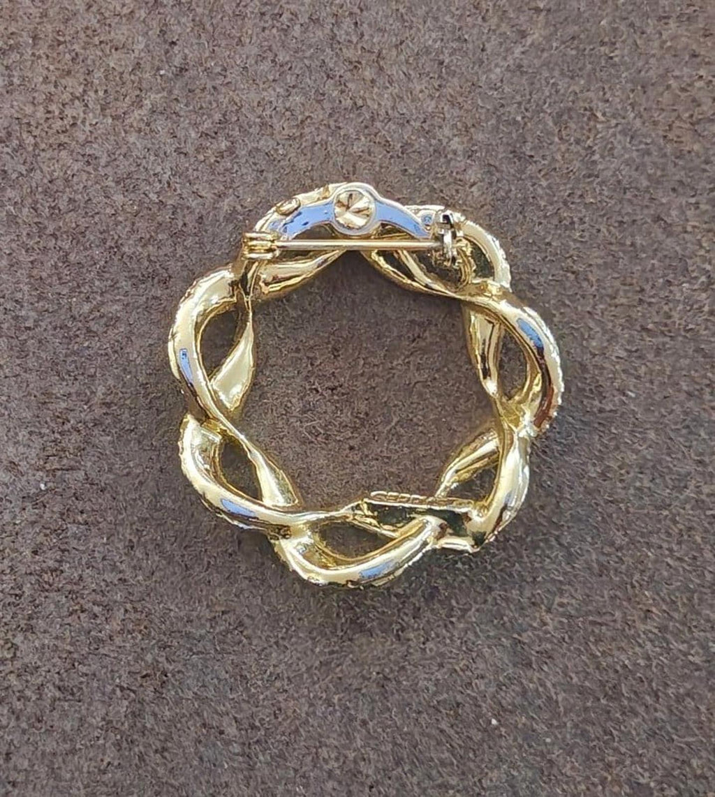 Gold-tone circular wreath brooch pin with leaf links and blue enamel highlights
