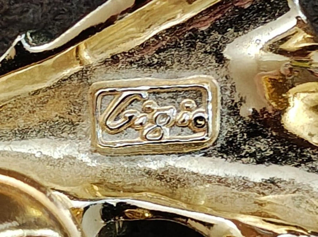 Gold-tone hallmark on angel brooch pin back, rectangular stamped maker mark