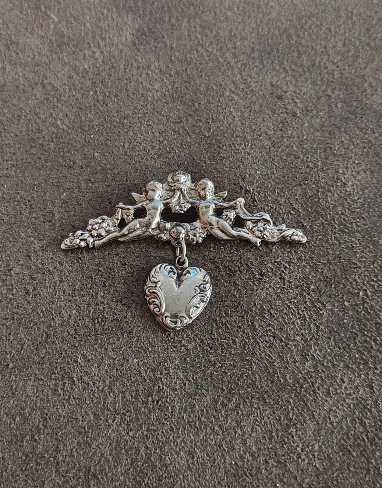 1980s Silver Tone Renaissance Style Cherub Brooch With Dangling Heart Charm