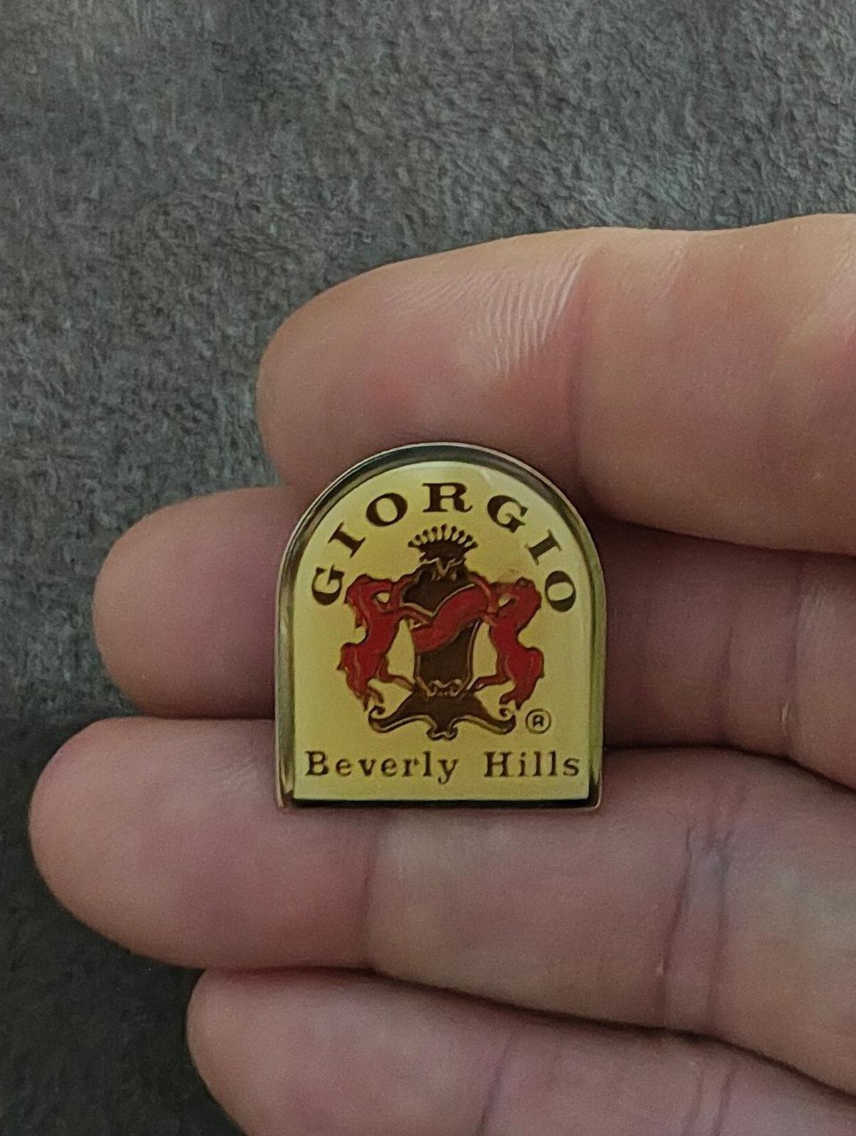 Gold-tone enamel crest pin with red lion, black details, and "Beverly Hills" lettering