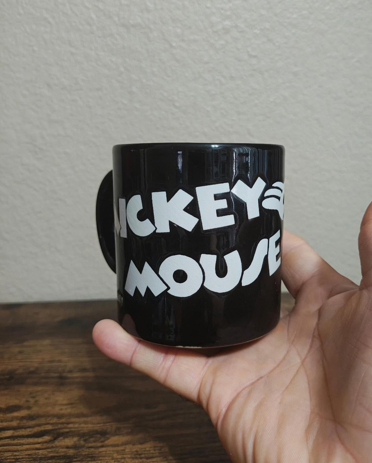 Black mug with white “MICKEY” and “MOUSE” text graphic