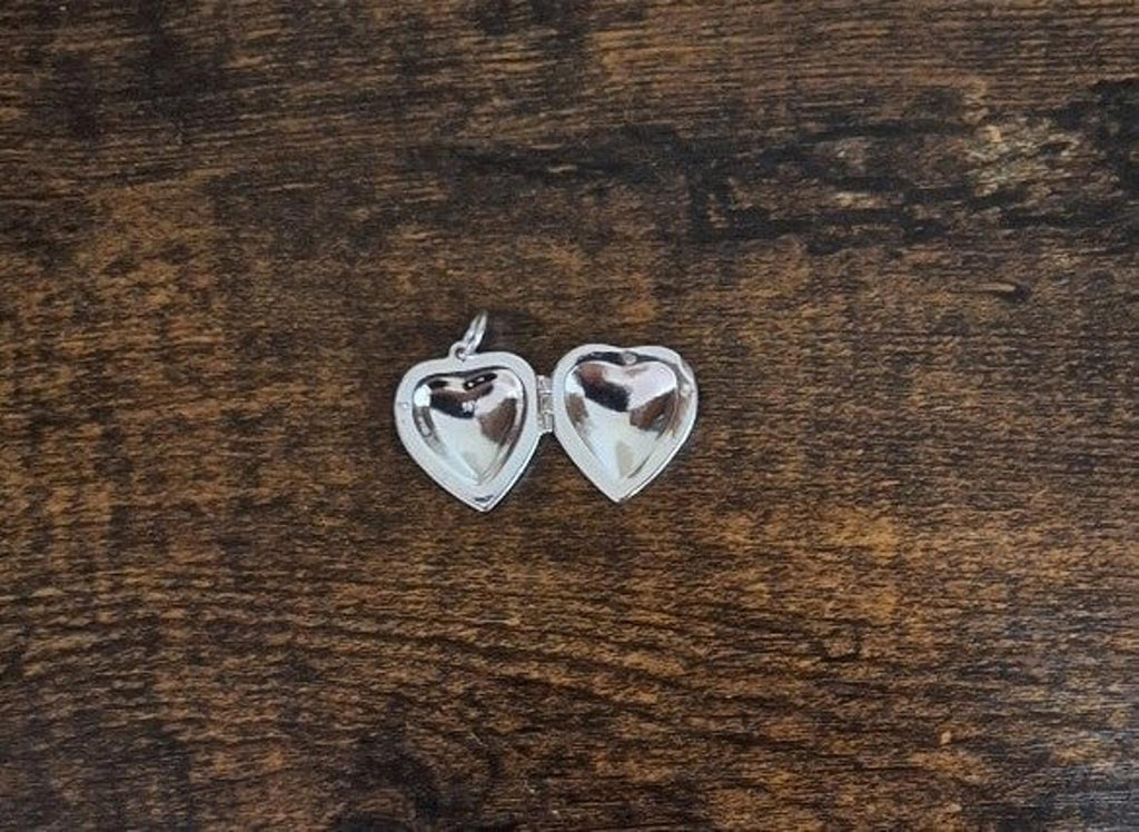 Silver heart locket pendant front and back views with rhinestone detailing