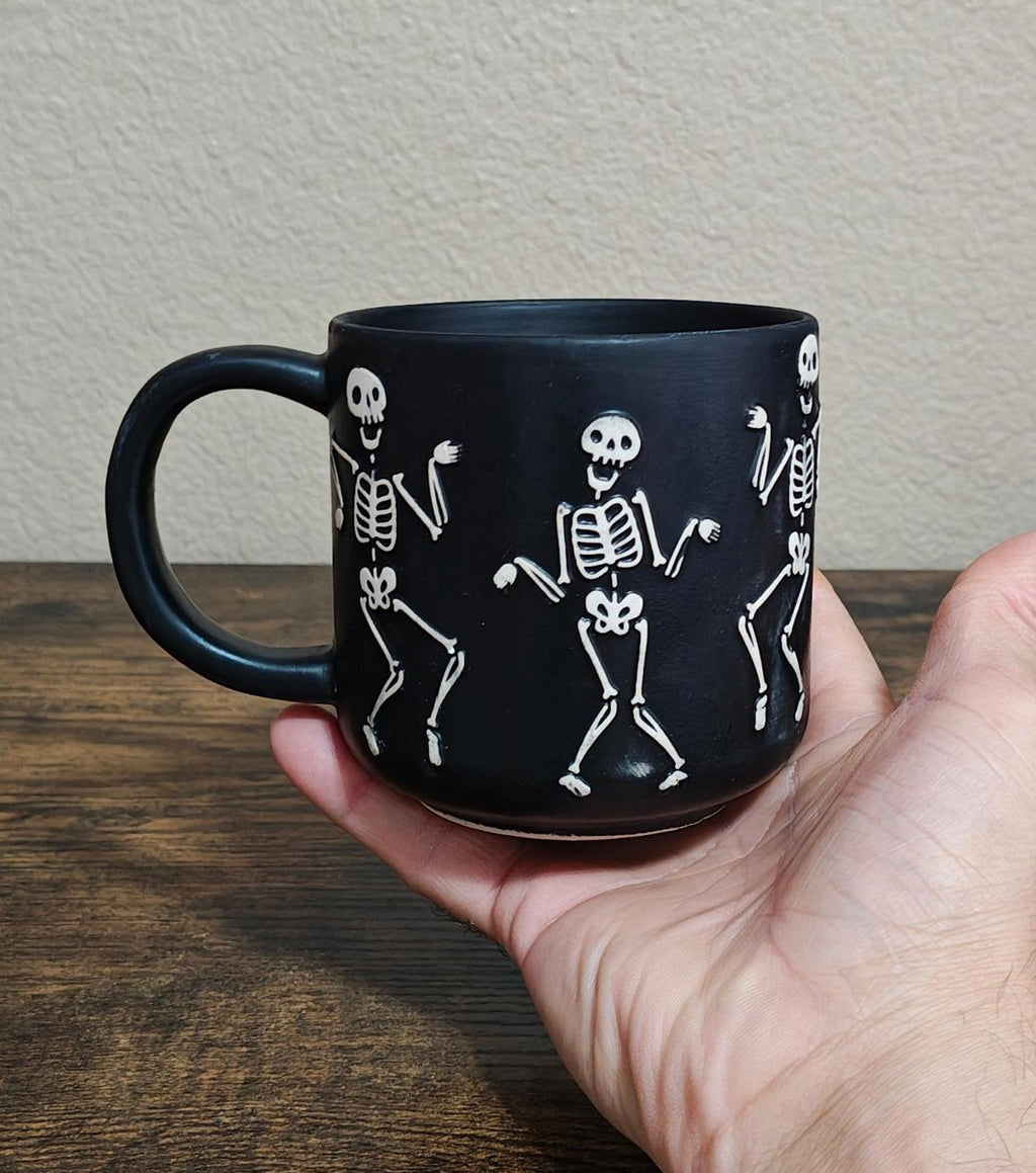 Dancing Skeletons Black Earthenware 13 oz 3D Embossed Black Mug.