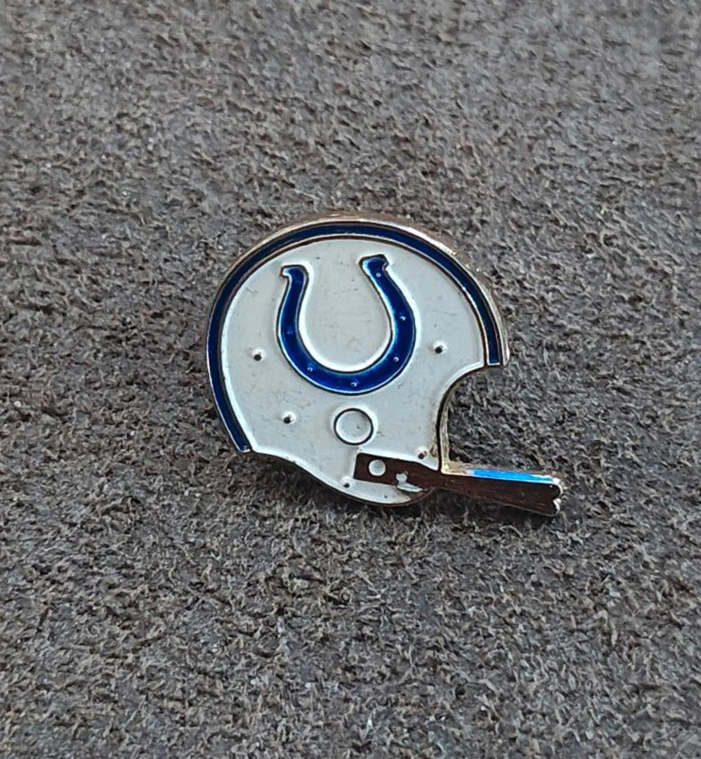 Gold-tone enamel tie clip with a white helmet and blue horseshoe emblem