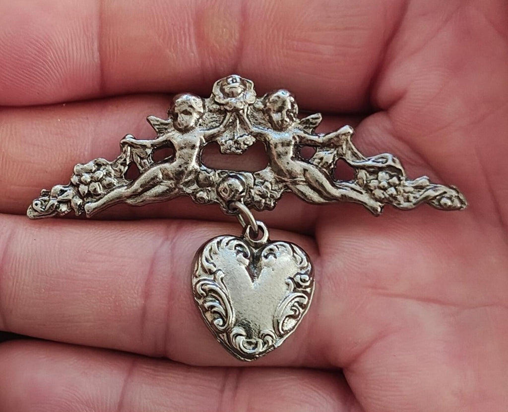 1980s Silver Tone Renaissance Style Cherub Brooch With Dangling Heart Charm