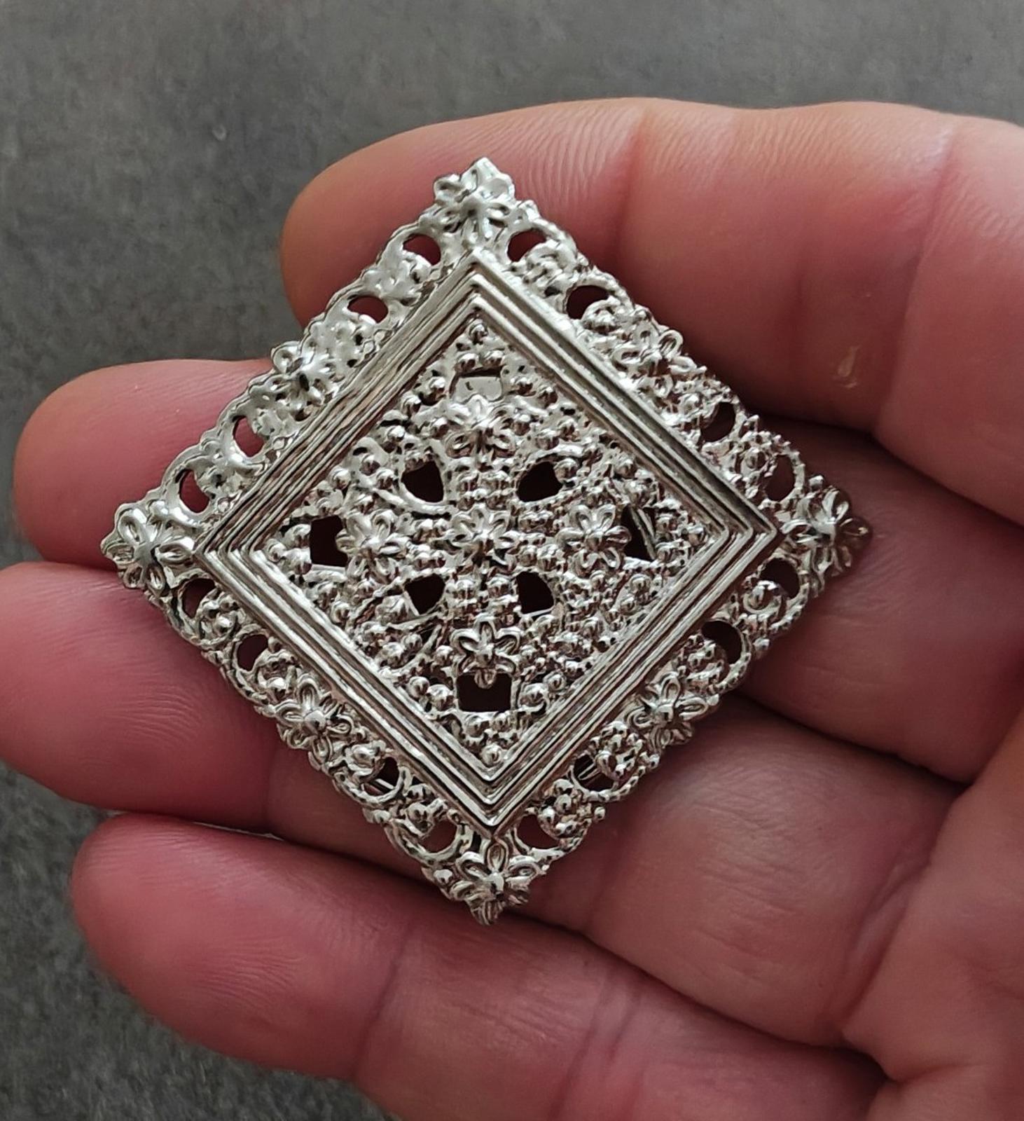 Silver-tone square filigree scarf clip with openwork floral motif and ornate border