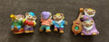 Three-piece dwarf figurine set: standing figures with one holding a small harp.