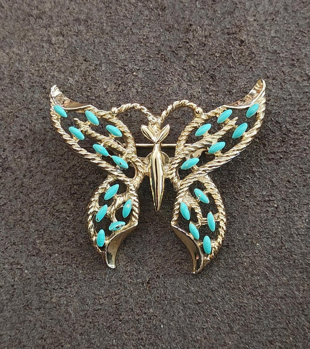 Gold-tone butterfly brooch with faux turquoise enamel, front view with wing details