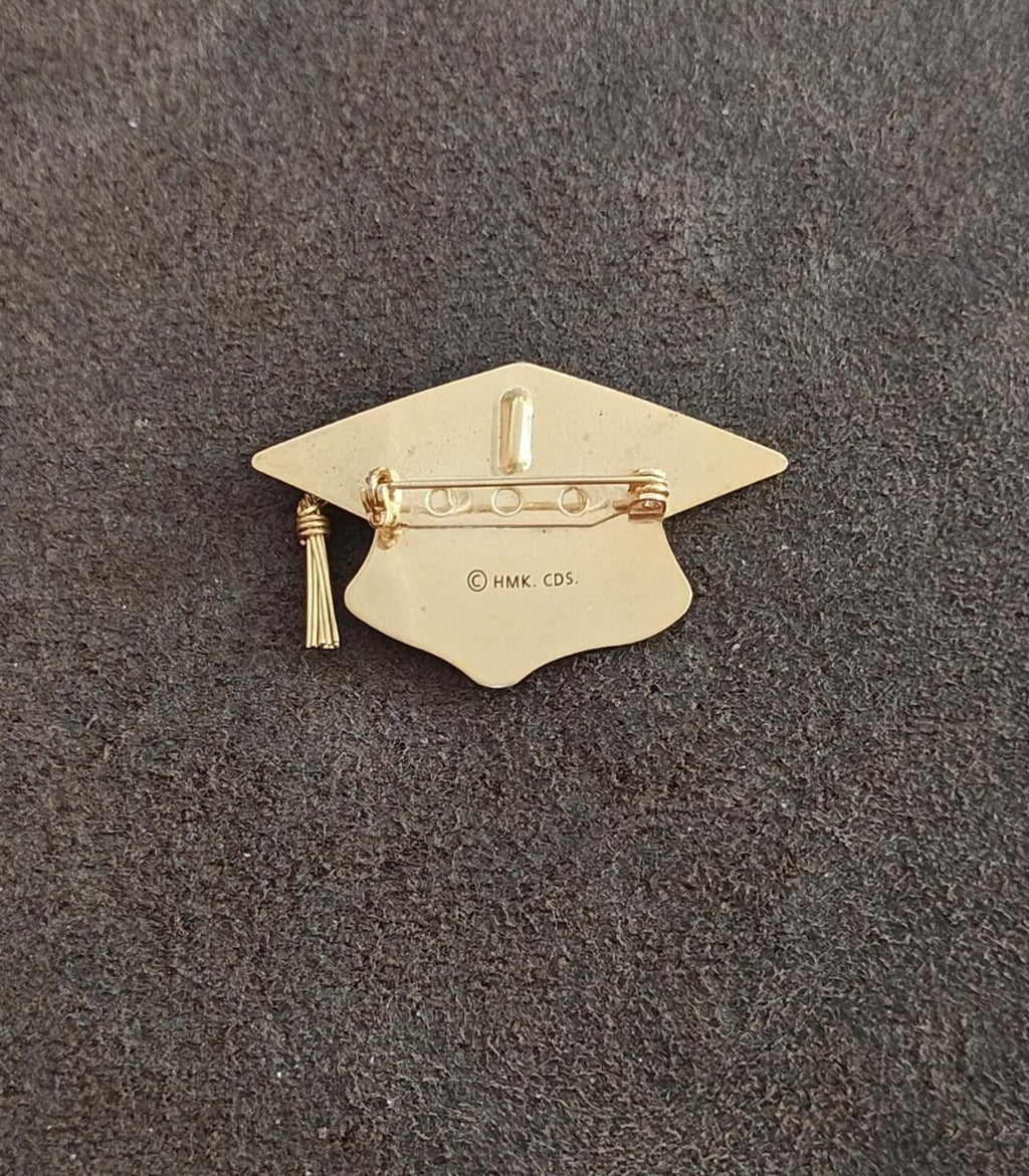 Gold-tone graduation cap brooch back with pin bar, tassel on left, stamped marking