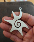 White enamel star pendant with spiral swirl design and small loop bail