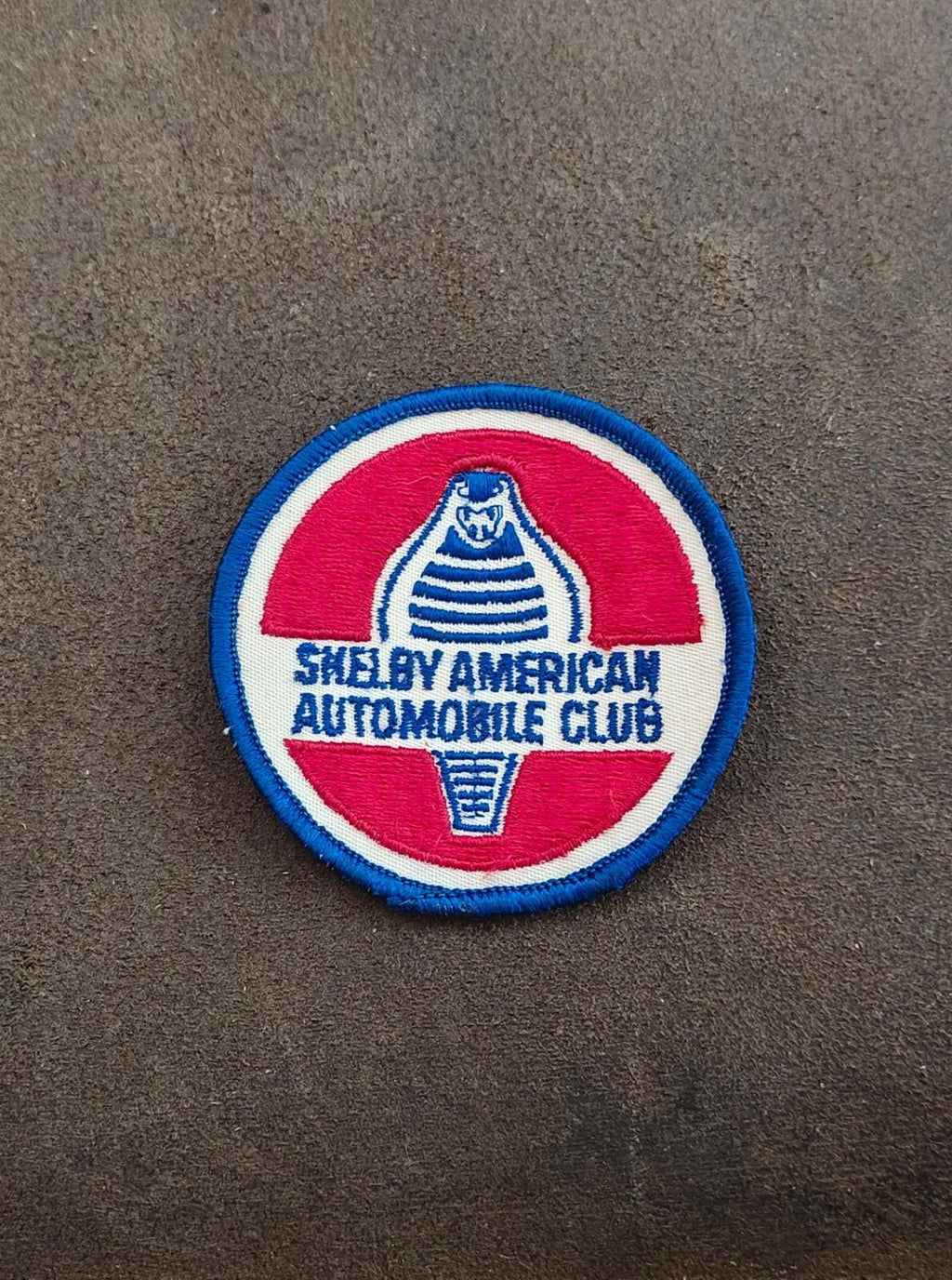 Round SAAC embroidered patch with blue edge, red and white center, club text