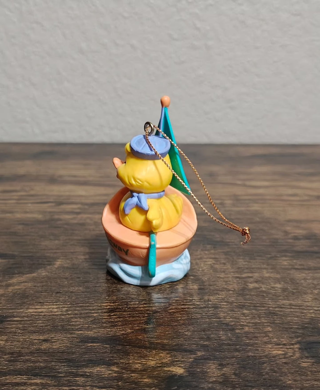 Easter sailboat ornament with yellow chick on peach boat, blue wave base, hanging loop