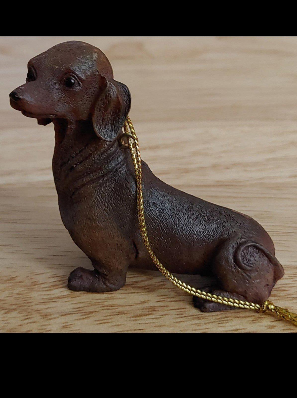 Chocolate brown dachshund ornament figurine, angled pose with gold hanging cord