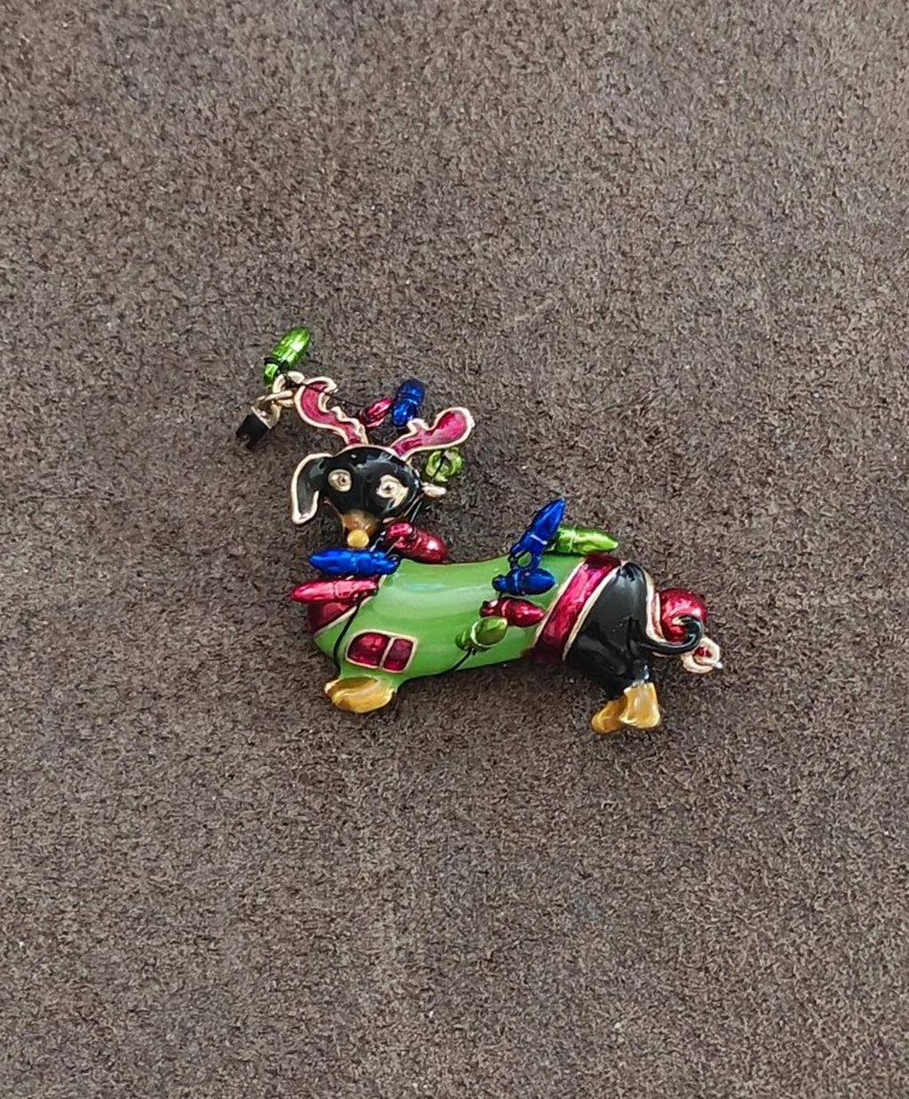 Colorful dachshund dog enamel brooch with green body and jeweled reindeer antlers