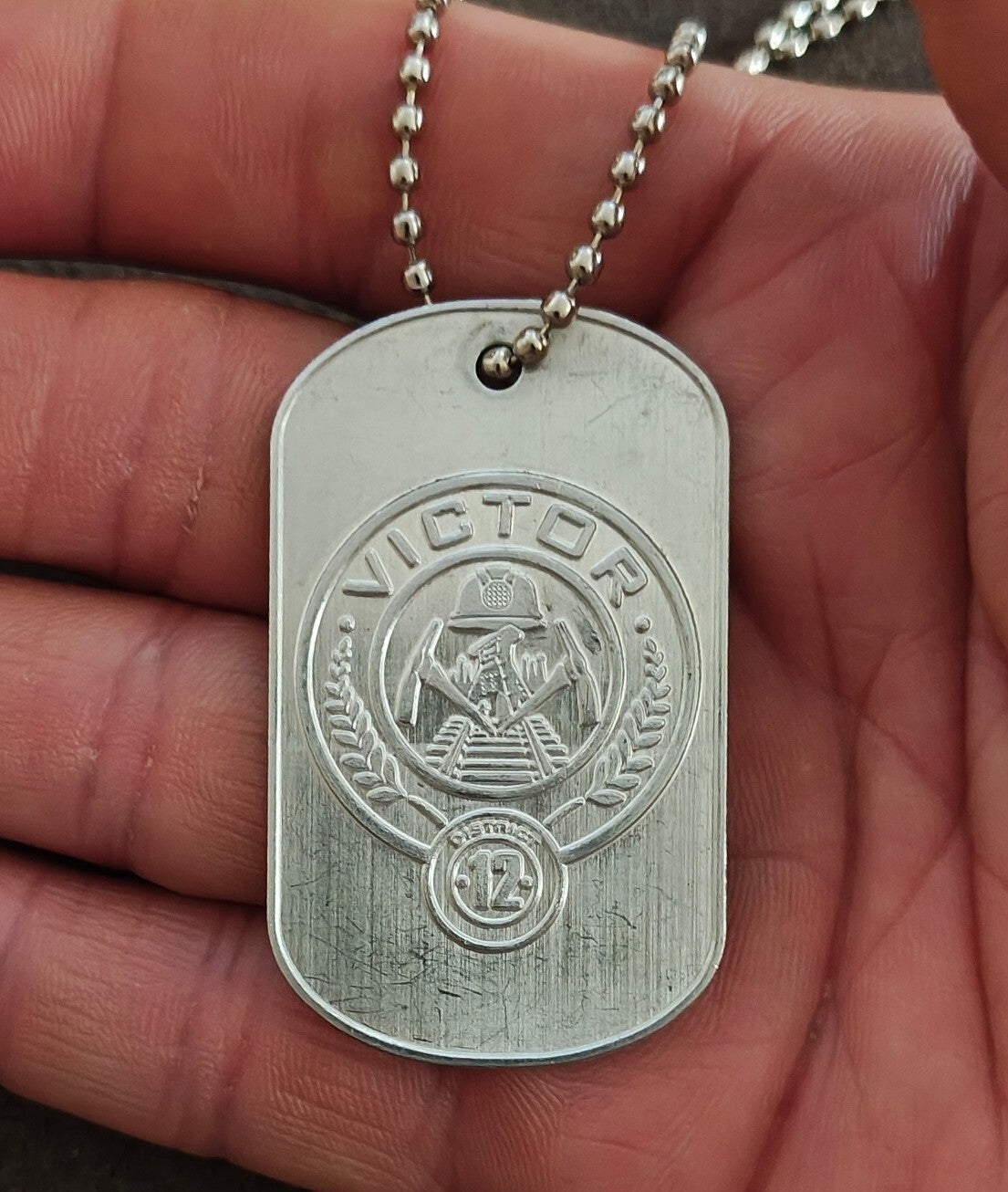 Promotional "The Hunger Games: Catching Fire" District 12 Victor Dog Tag
