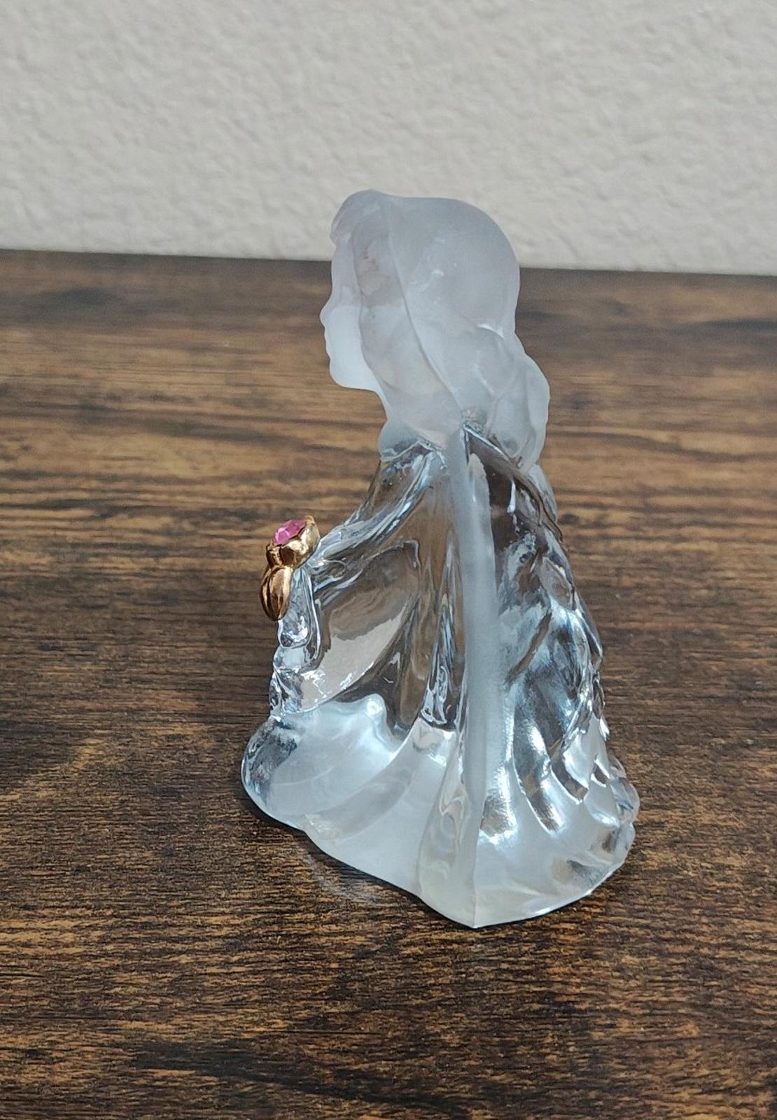Clear glass guardian angel figurine, side profile with pink gemstone at shoulder