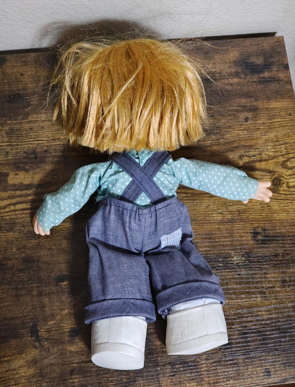 Boy collectible doll full back view, denim overalls with suspenders, blue dot shirt, white boots.
