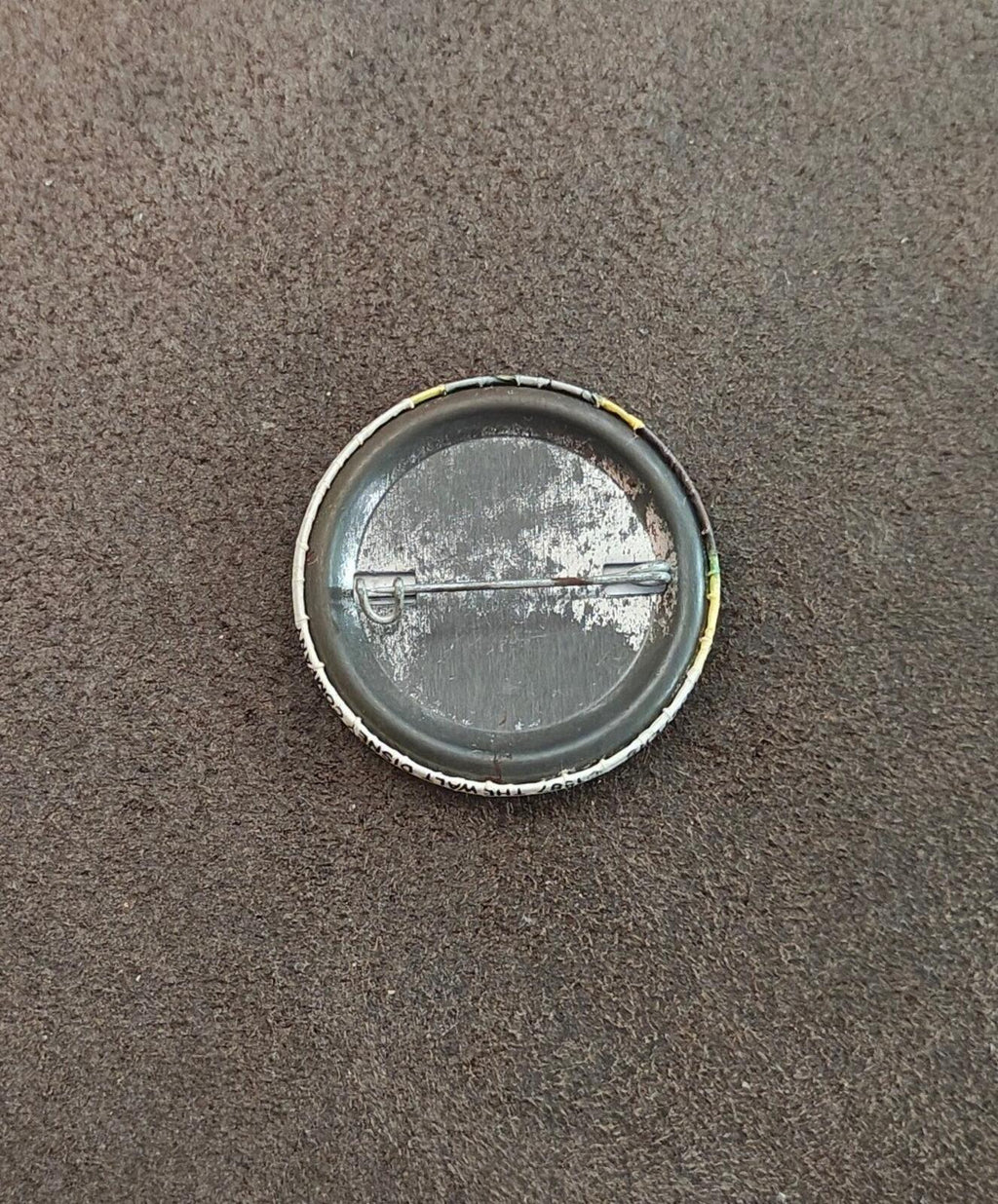 Goofy pinback button back side, silver metal disc with worn finish