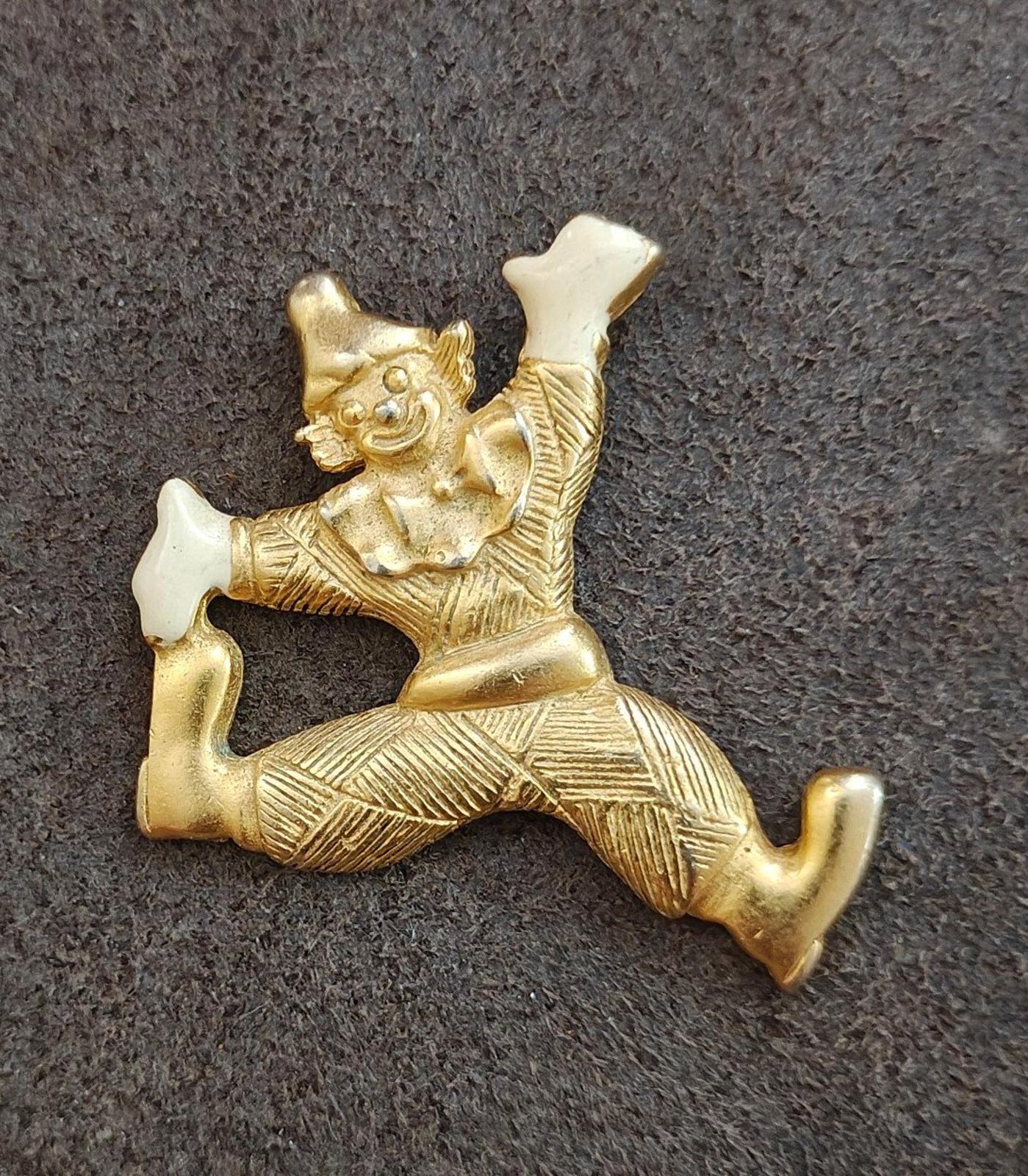 Gold tone clowning around pendant with white enamel hands and shoes, front-facing full figure