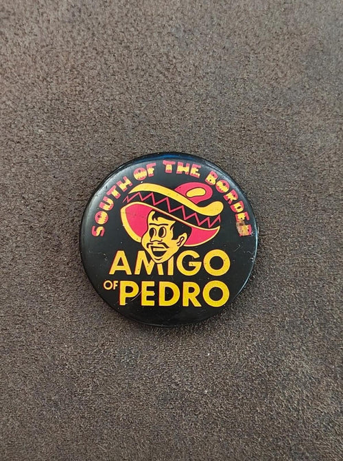 Black Amigos of Pedro pinback button with cowboy face and sombrero graphic