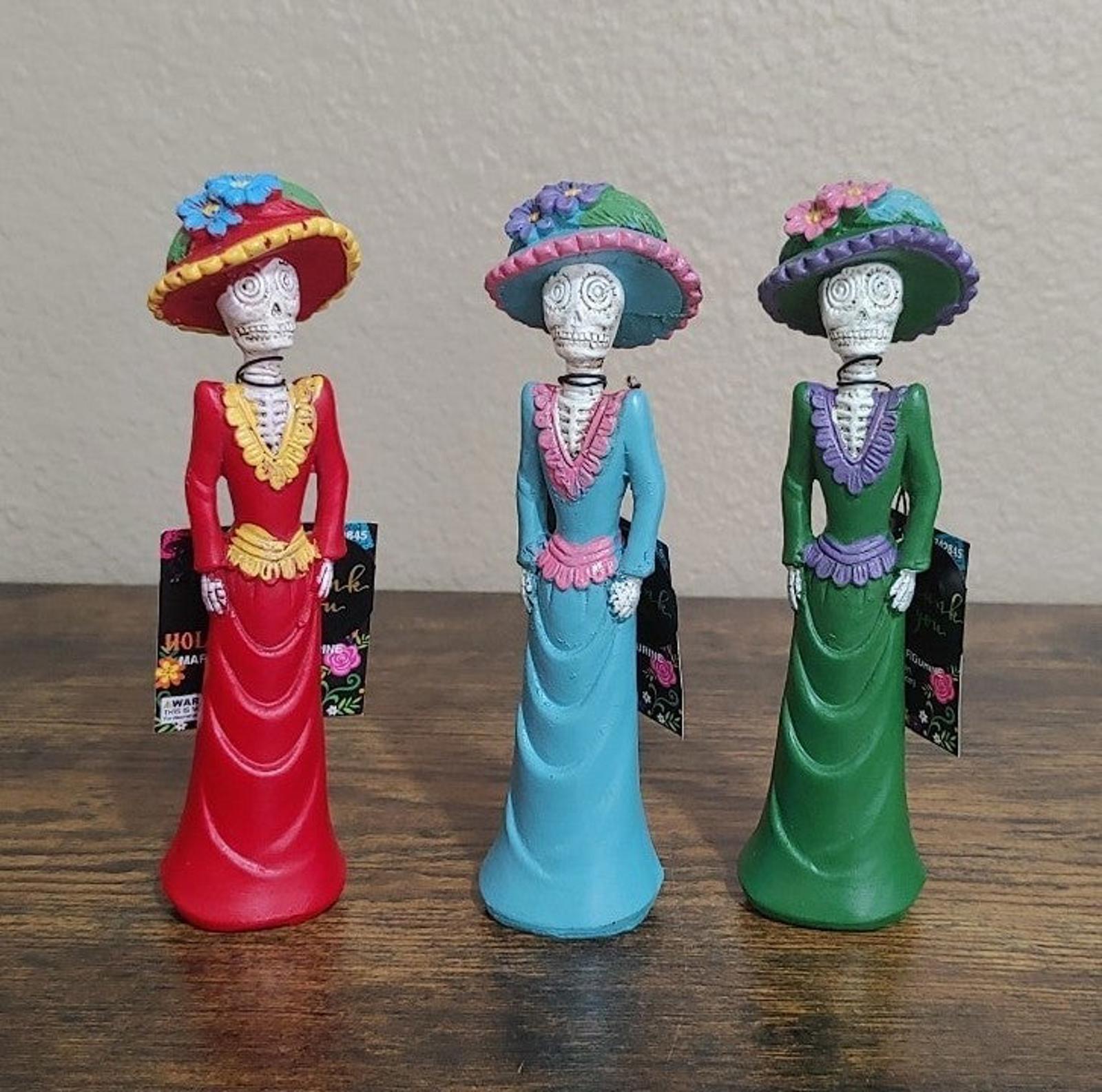 Set of three Day of the Dead lady figurines in red, blue, and green dresses