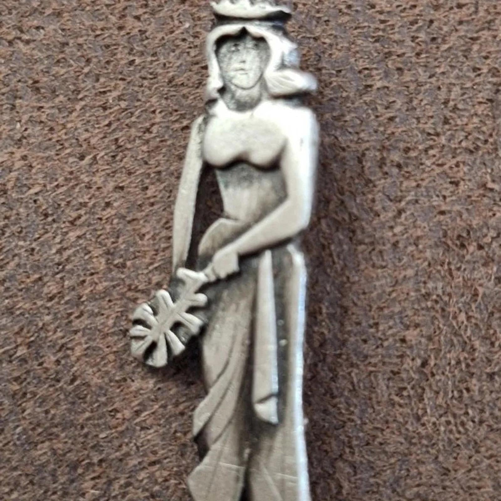 Metzke pewter girl brooch pin, angled front view holding staff, silver-tone