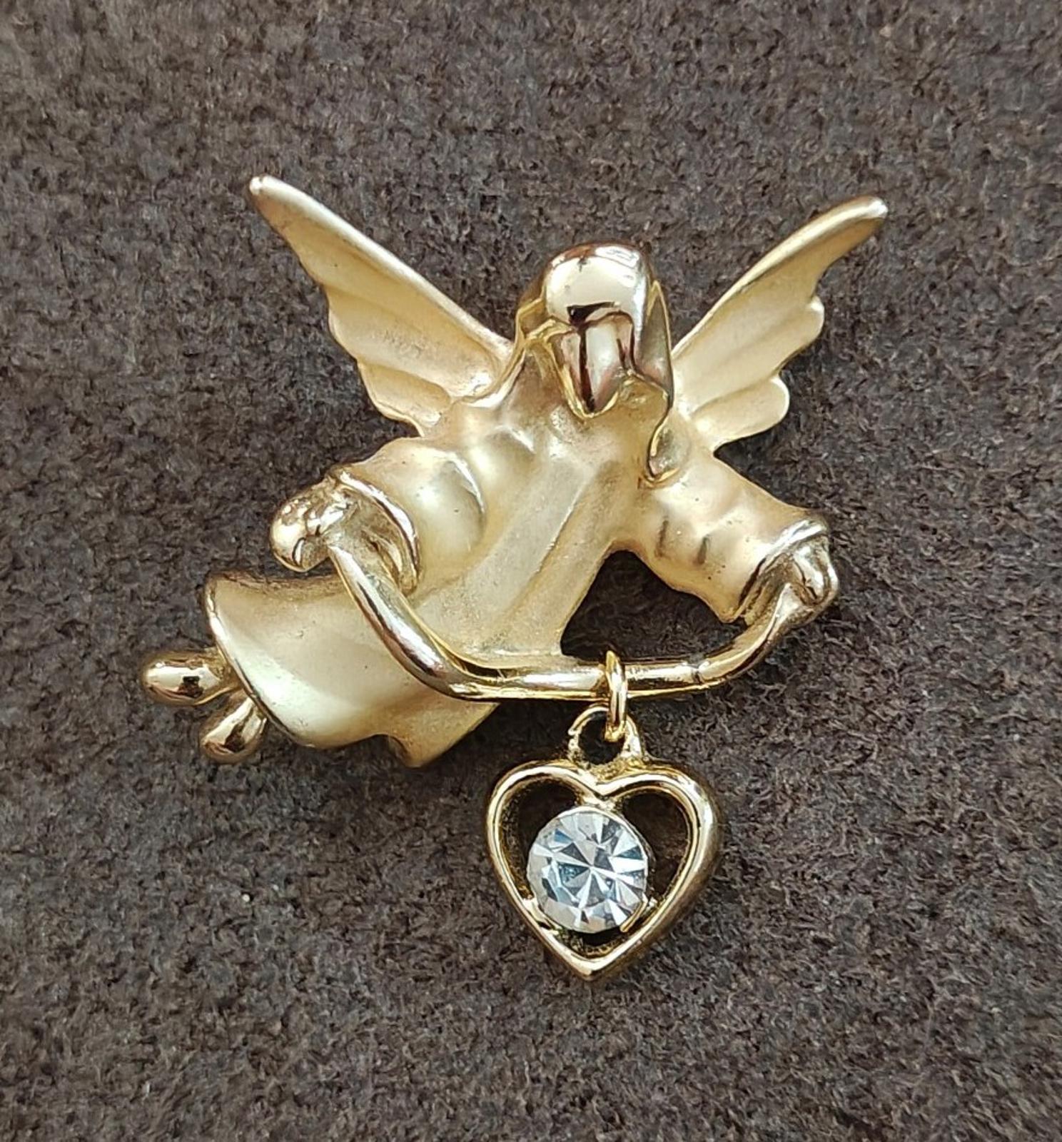 Gold-tone angel brooch pin with heart charm and bright round crystal stone