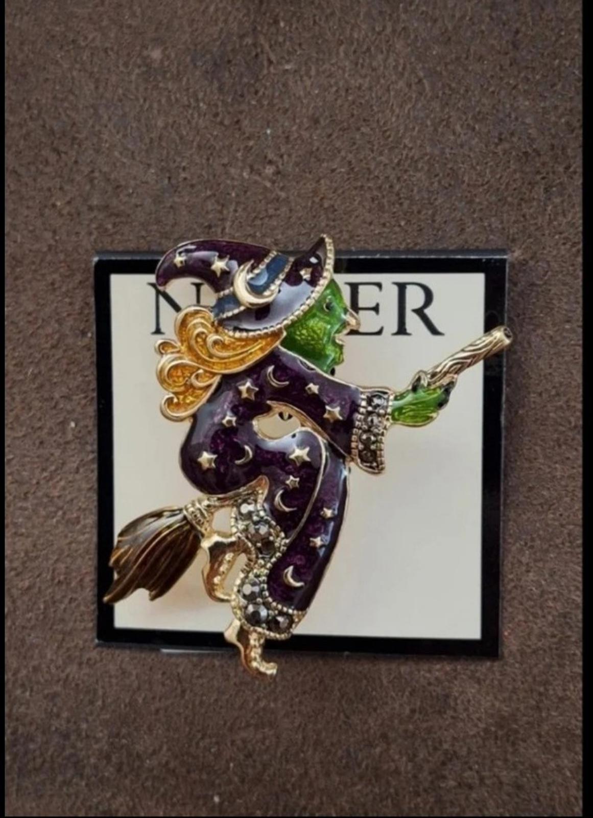 Gold-tone witch enamel pin brooch featuring dark purple star cloak and green broom