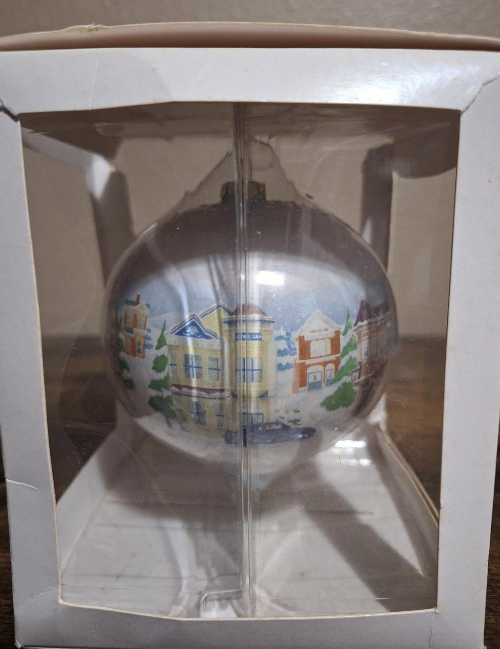 Hallmark Keepsake teardrop ornament with Main Street buildings and a tall tower detail