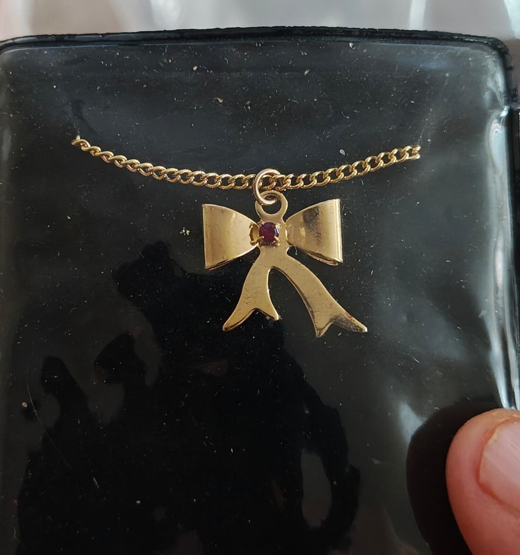 1980s 14k Gold Tone Bow Pendant Necklace With Vibrant Red Stone