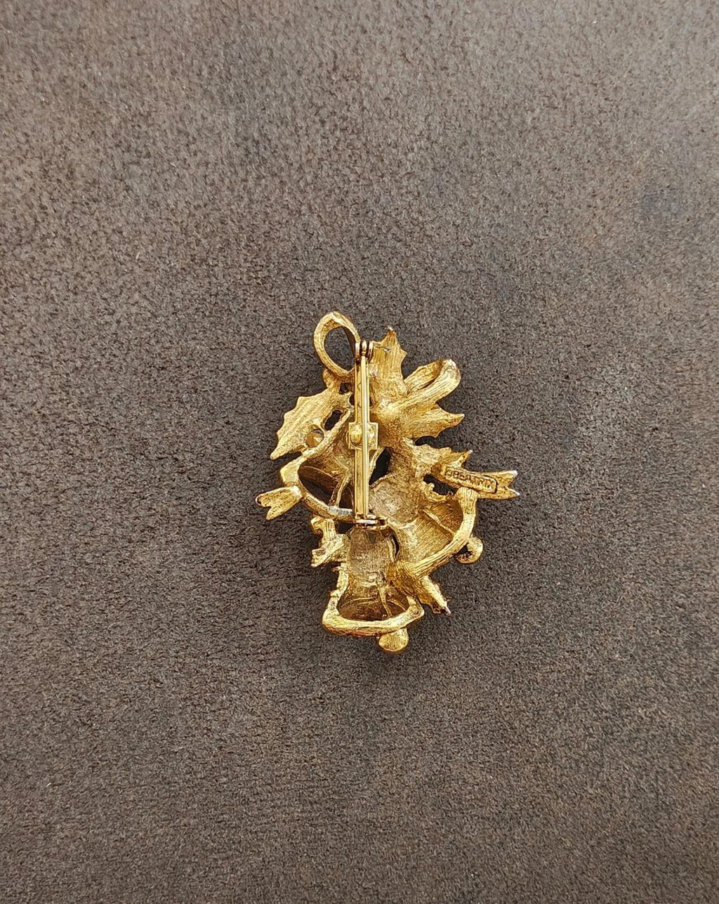 Gold tone Christmas bell brooch back view with pin stem and clasp visible