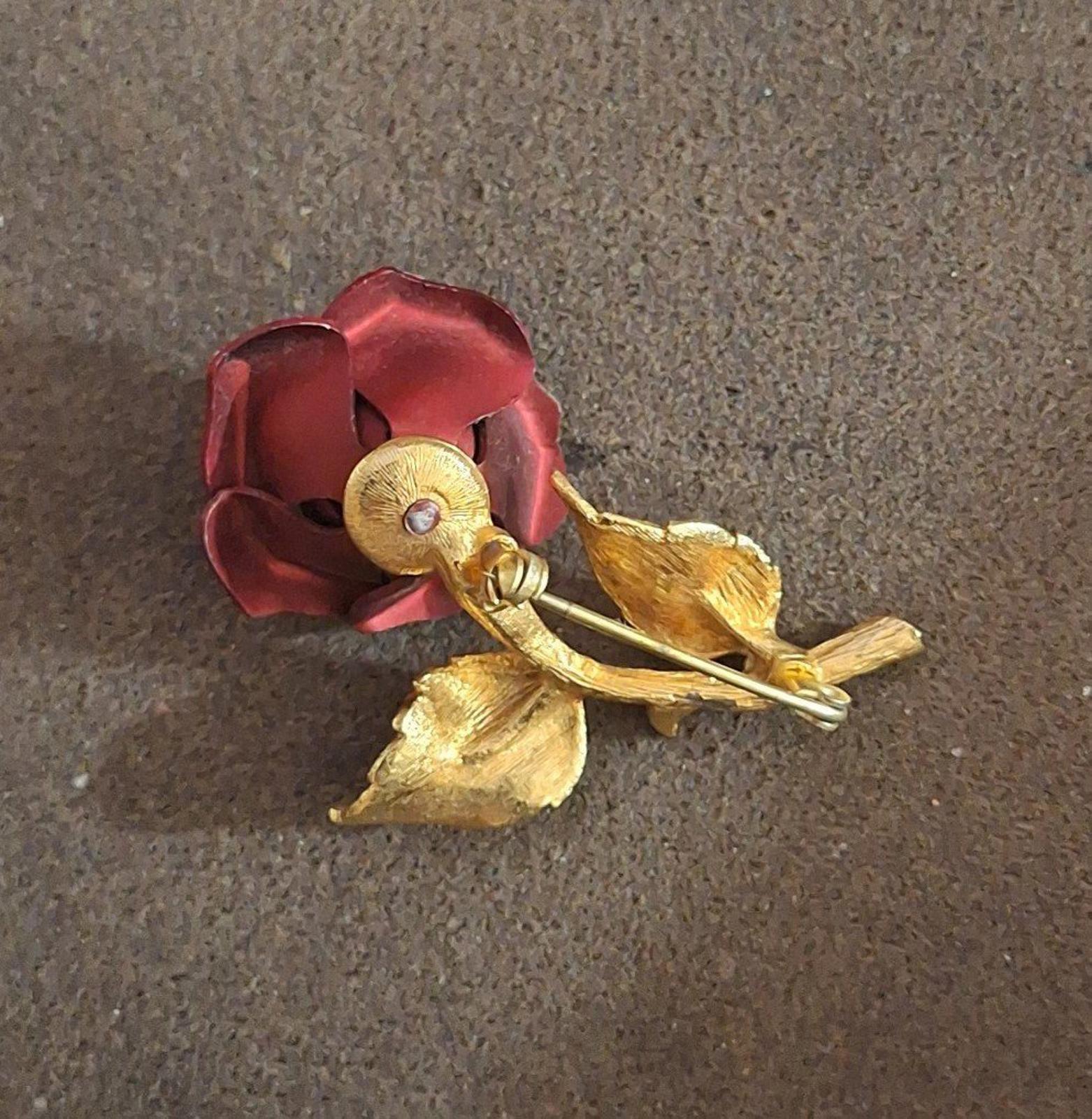 Gold-tone red rose enamel pin brooch back with locking pin and leaf details.