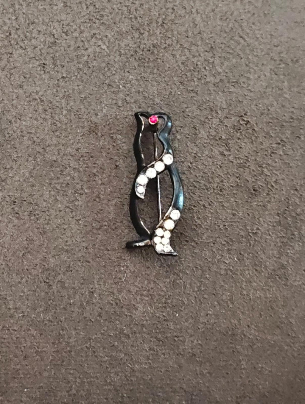 Black enamel penguin brooch with scattered clear rhinestones and small red heart detail