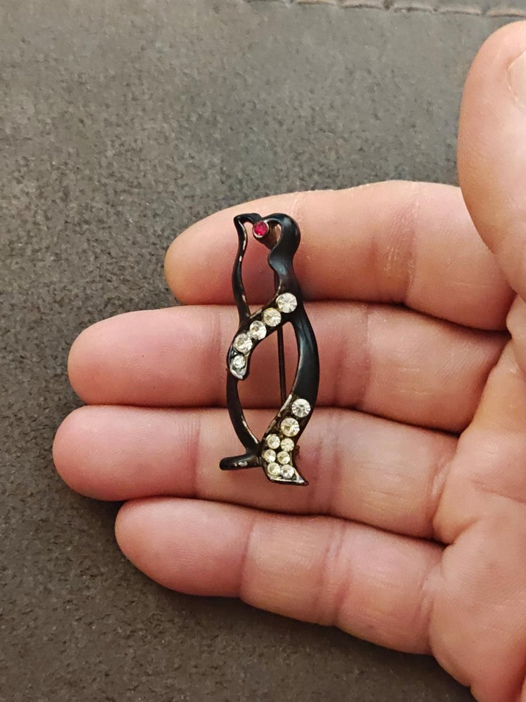 Black enamel penguin brooch with clear rhinestone belly rows and red heart at top