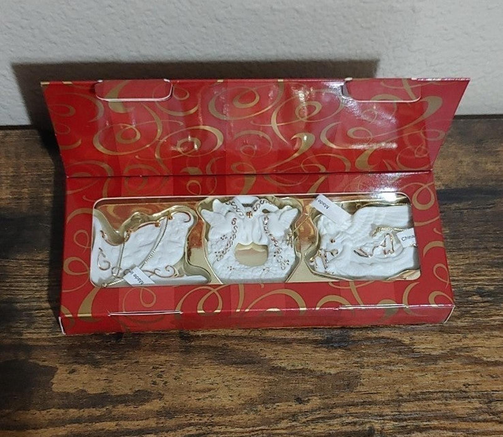 Set of three bisque porcelain ornaments in red gift box with gold trim