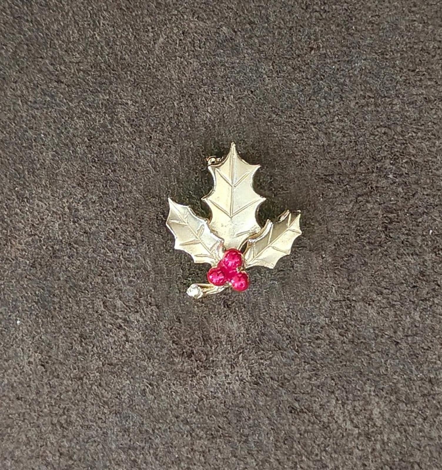 Holly leaf brooch with red enamel berries and gold-tone metal setting