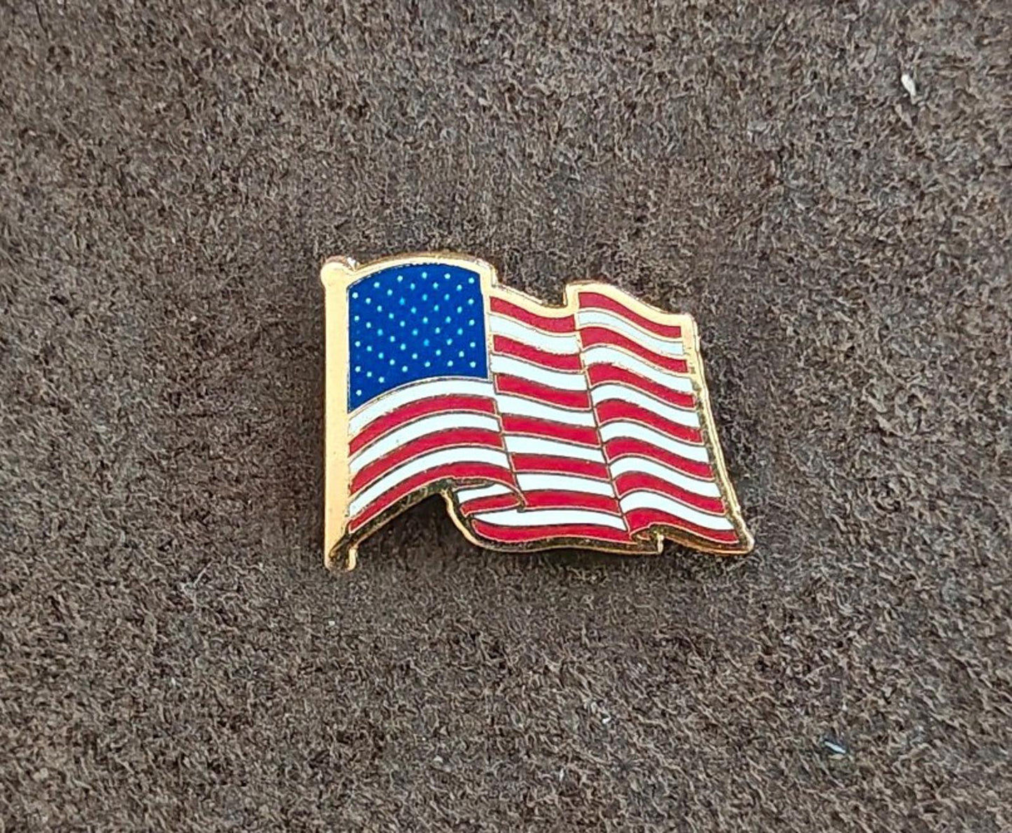 1980s Patriotic Gold Tone Enameled American Wavy Flag Pin.