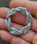 Silver-tone circular leaf textured pin brooch with open center