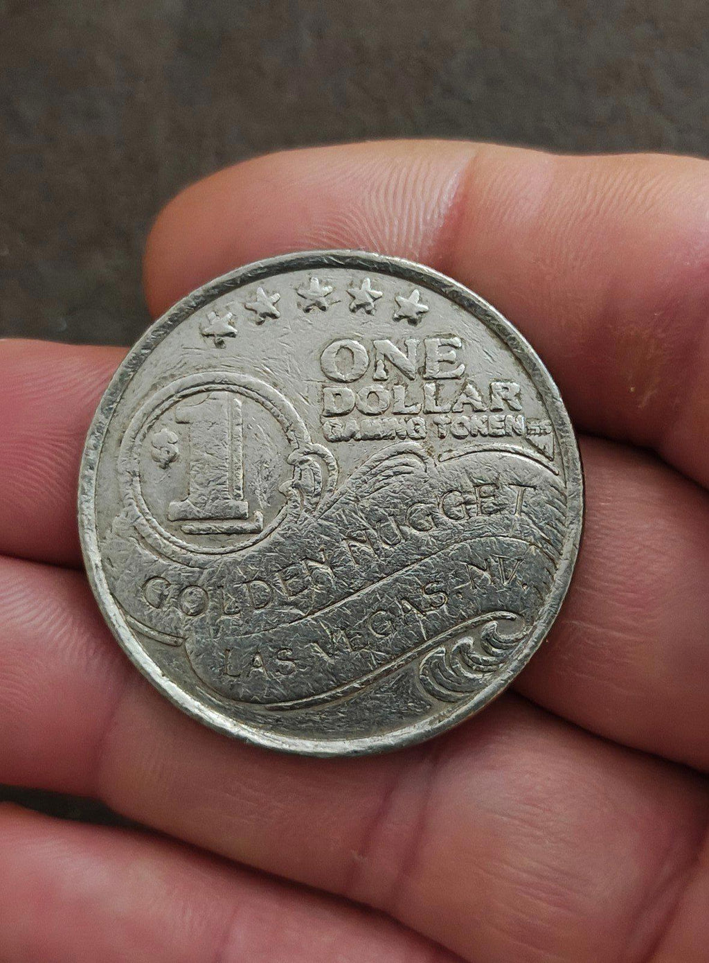 Silver Golden Nugget one-dollar slot token showing ONE DOLLAR, 1, and LAS VEGAS.