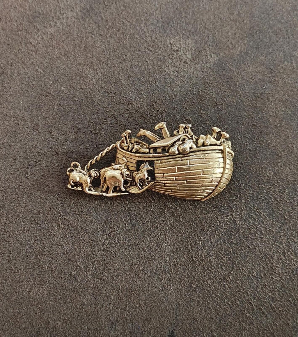 Gold tone Noah’s Ark brooch showing the boat and chain with small animal accents
