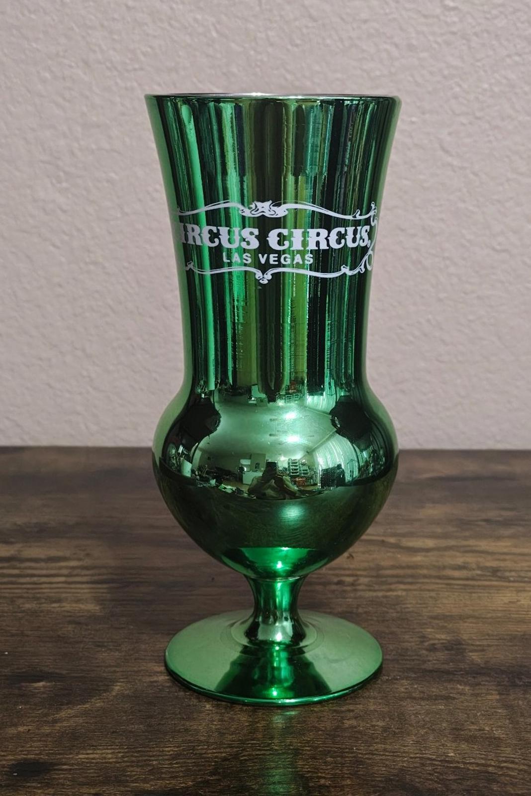 Green mirrored hurricane glass, front view with Circus Circus Las Vegas logo.