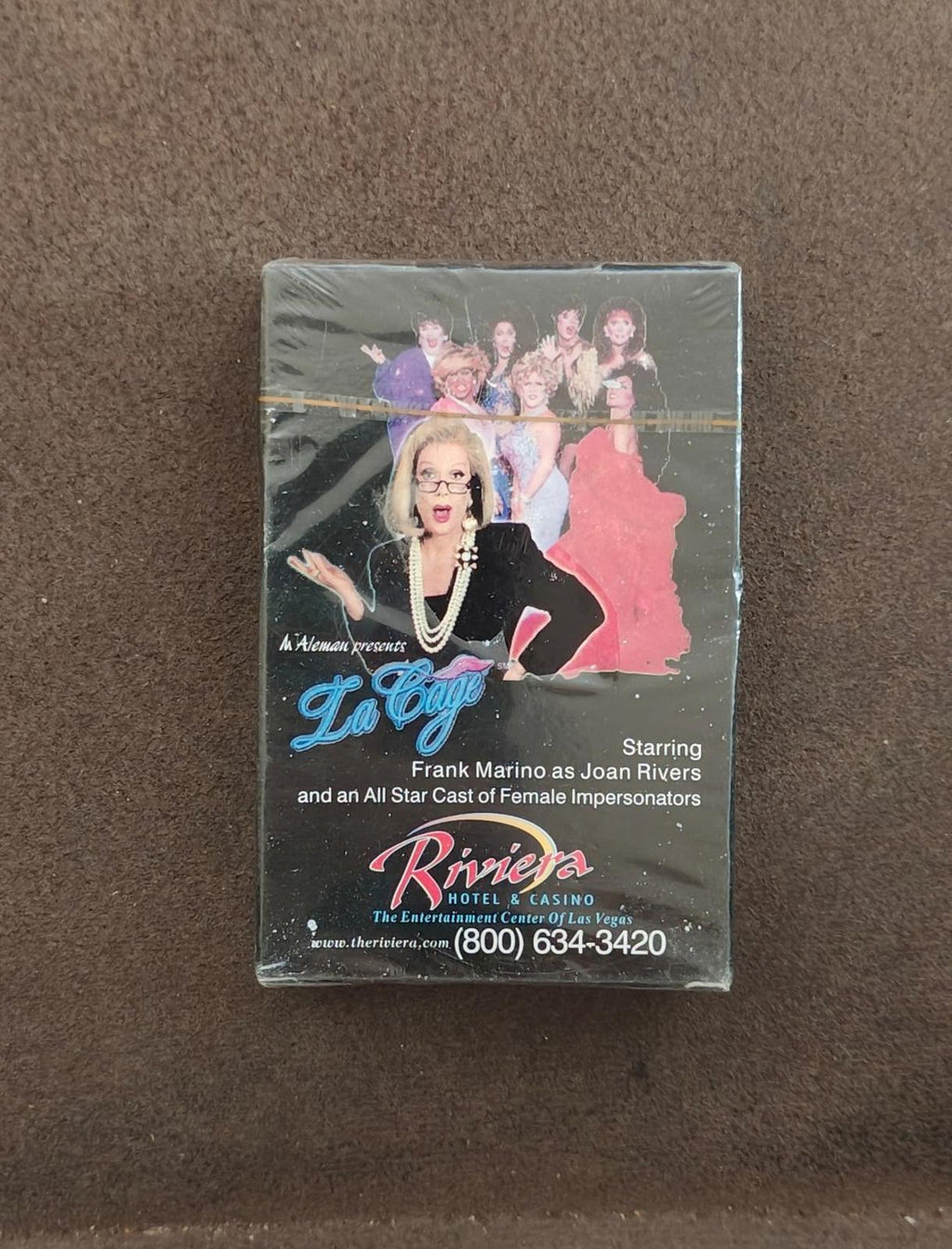 Sealed black playing card deck box with La Cage cover art and Riviera Hotel & Casino branding