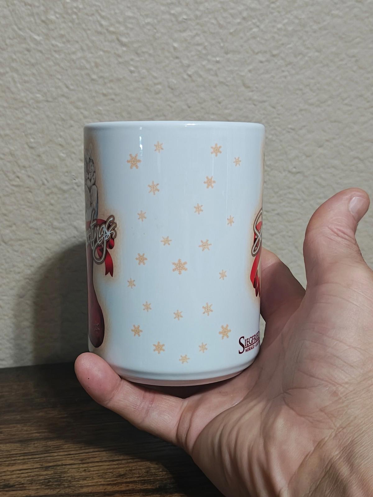 White porcelain mug side view with small gold star pattern and red ribbon accents