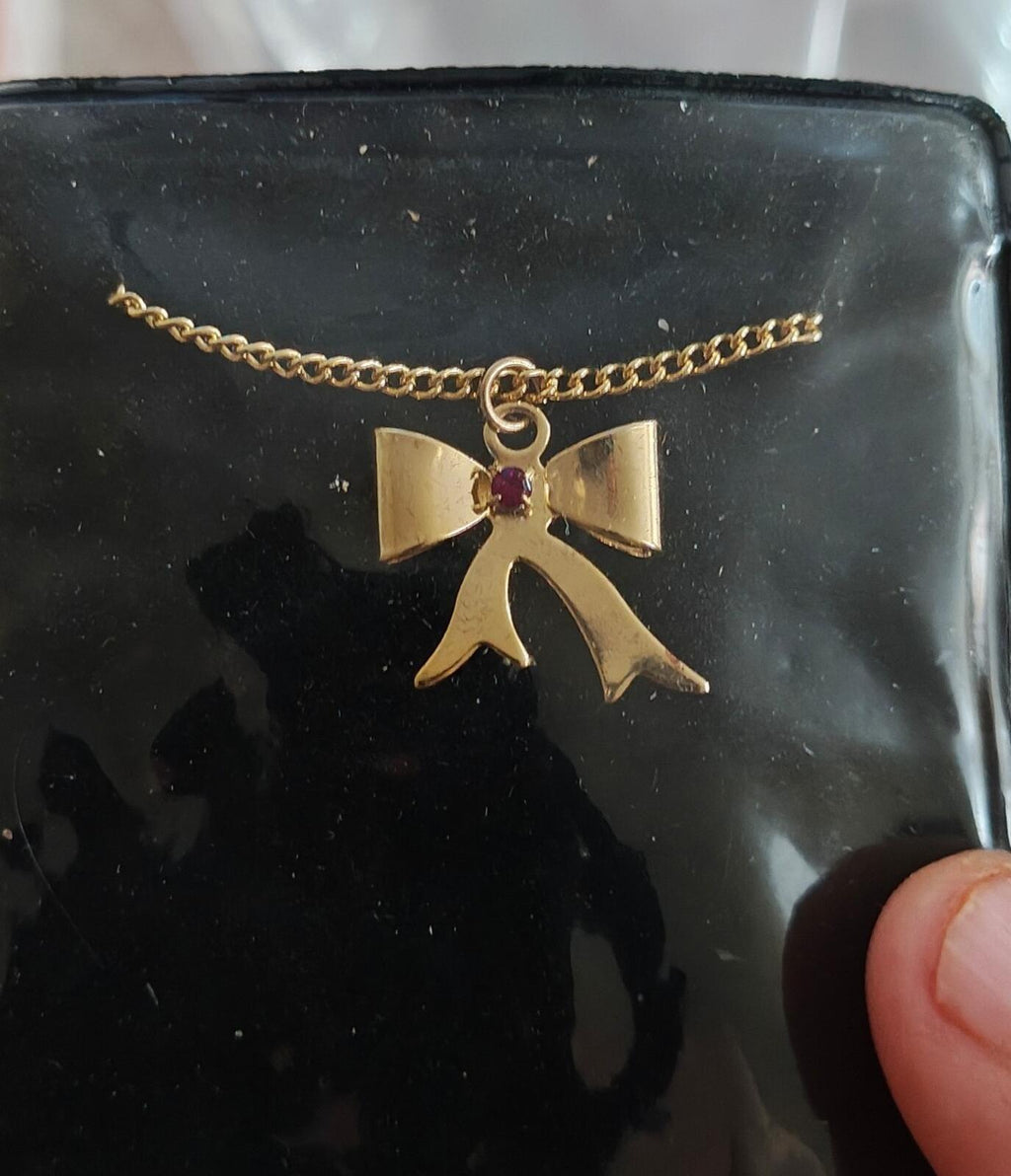 1980s 14k Gold Tone Bow Pendant Necklace With Vibrant Red Stone